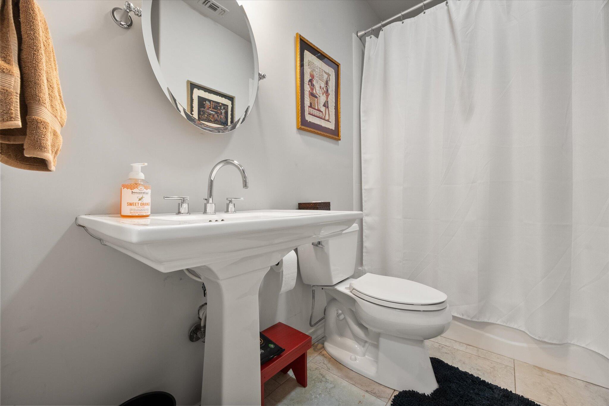 6021 89th Street Lubbock, TX 79424 - Photo 34 of 41 a bathroom with a sink toilet and a mirror