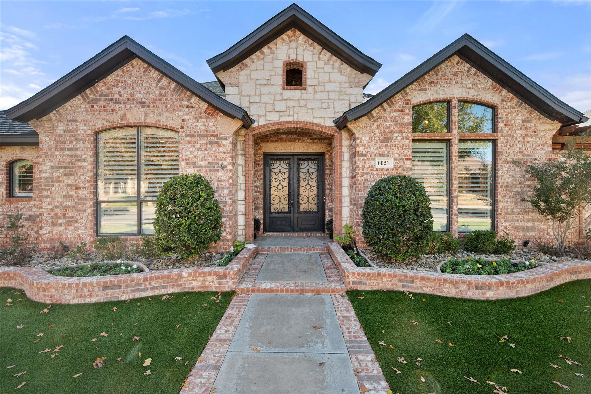 6021 89th Street Lubbock, TX 79424 - Photo 5 of 41 a front view of a house with a yard