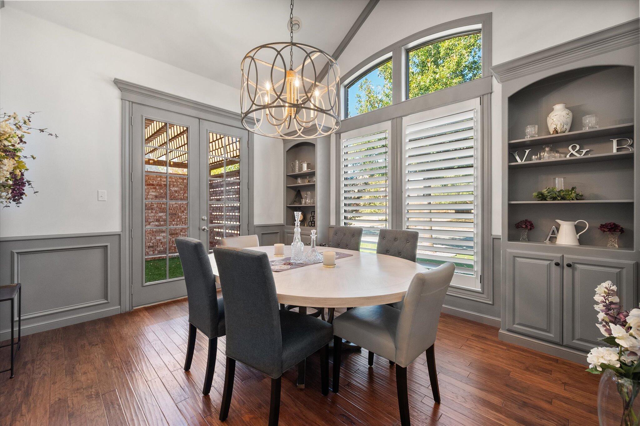 6021 89th Street Lubbock, TX 79424 - Photo 8 of 41 a view of a dining room with furniture a chandelier and wooden floor
