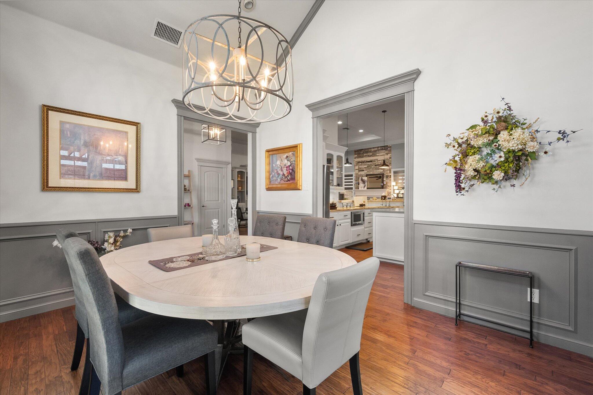 6021 89th Street Lubbock, TX 79424 - Photo 9 of 41 a view of a dining room with furniture and wooden floor