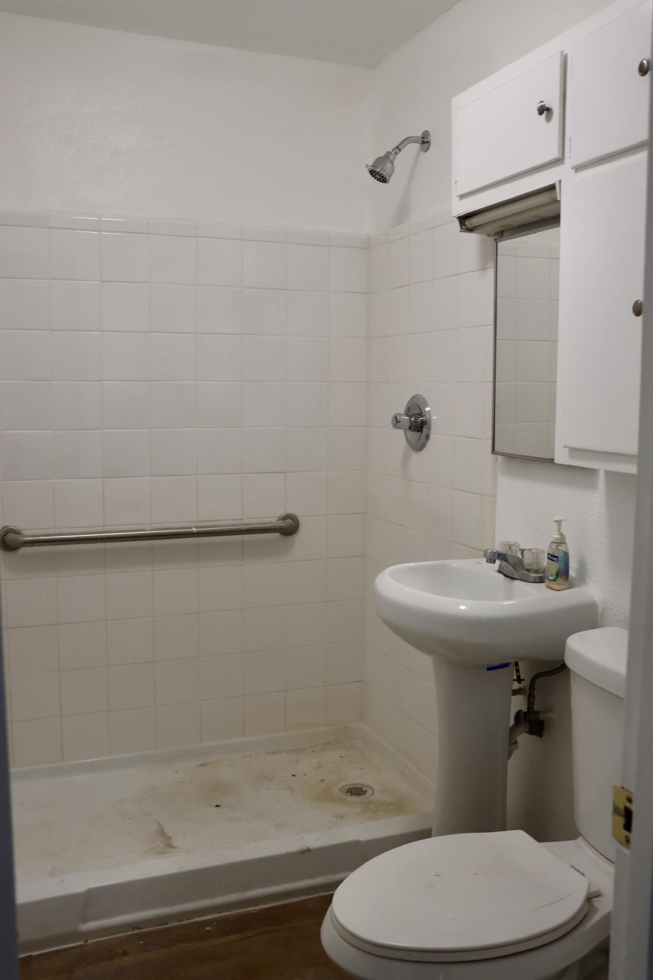 1511 36th Street Lubbock, TX 79412 - Photo 13 of 13 a bathroom with a sink a toilet and shower