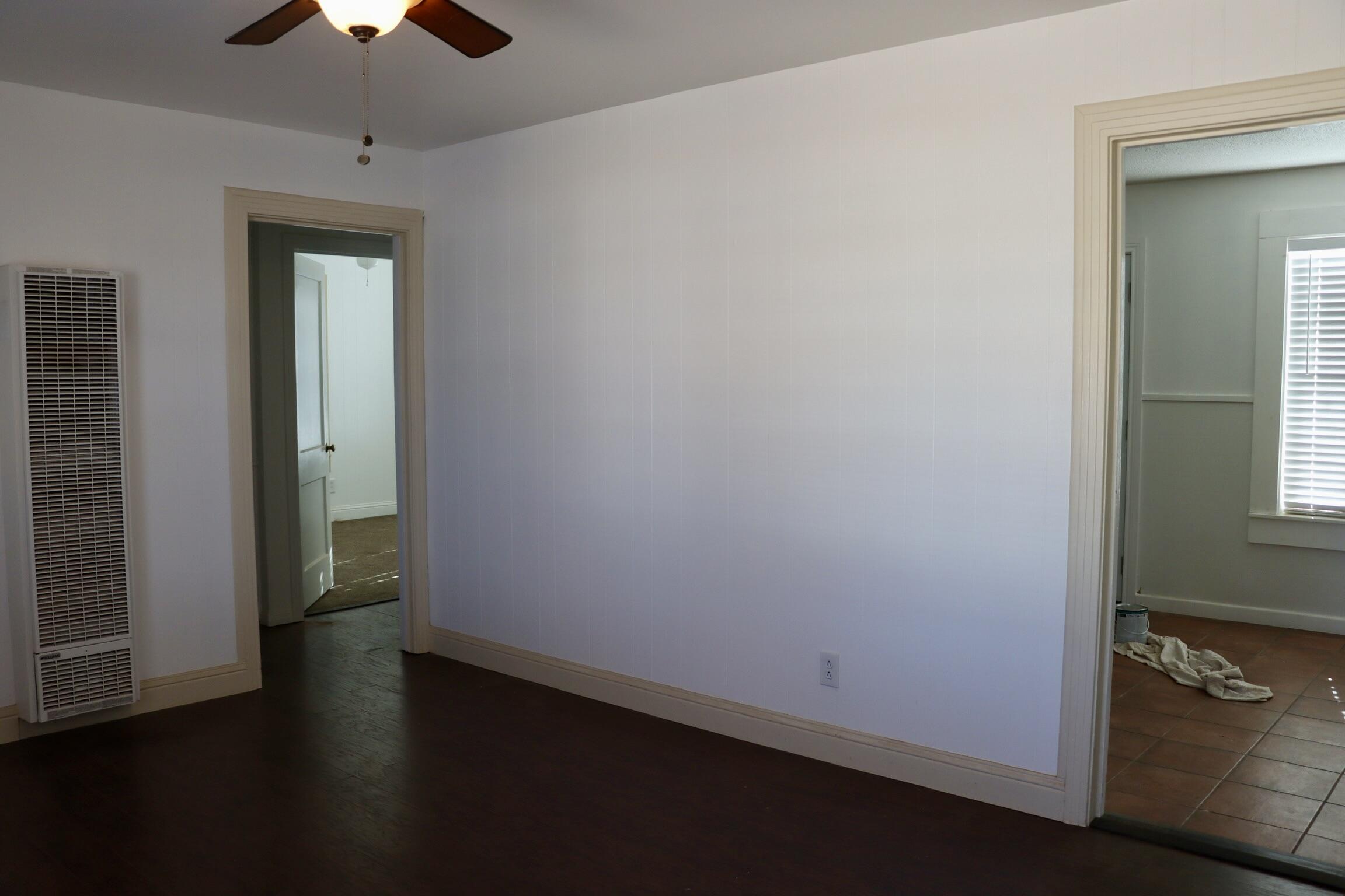 1511 36th Street Lubbock, TX 79412 - Photo 3 of 13 wooden floor in an empty room with a window