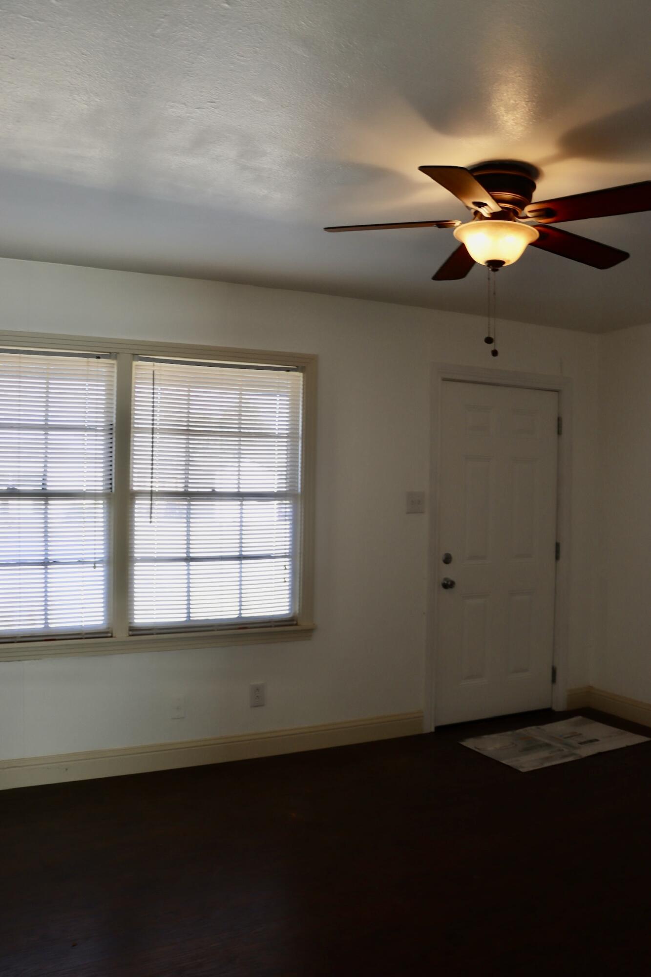 1511 36th Street Lubbock, TX 79412 - Photo 9 of 13 a view of room with a ceiling fan and window