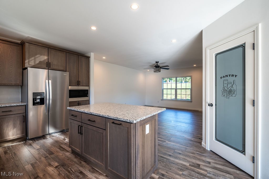 7343 Lost Pavement Road Belleville, WV 26133 - Photo 48 of 49 Kitchen with stainless steel appliances, recessed lighting, light stone counters, open floor plan, and a kitchen island