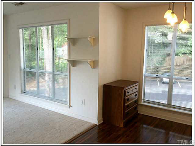 4601 Timbermill Court, Unit 301 Raleigh, NC 27612 - Photo 4 of 8 Living room, dining room, and kitchen are open to one another, creating a feeling of spaciousness.