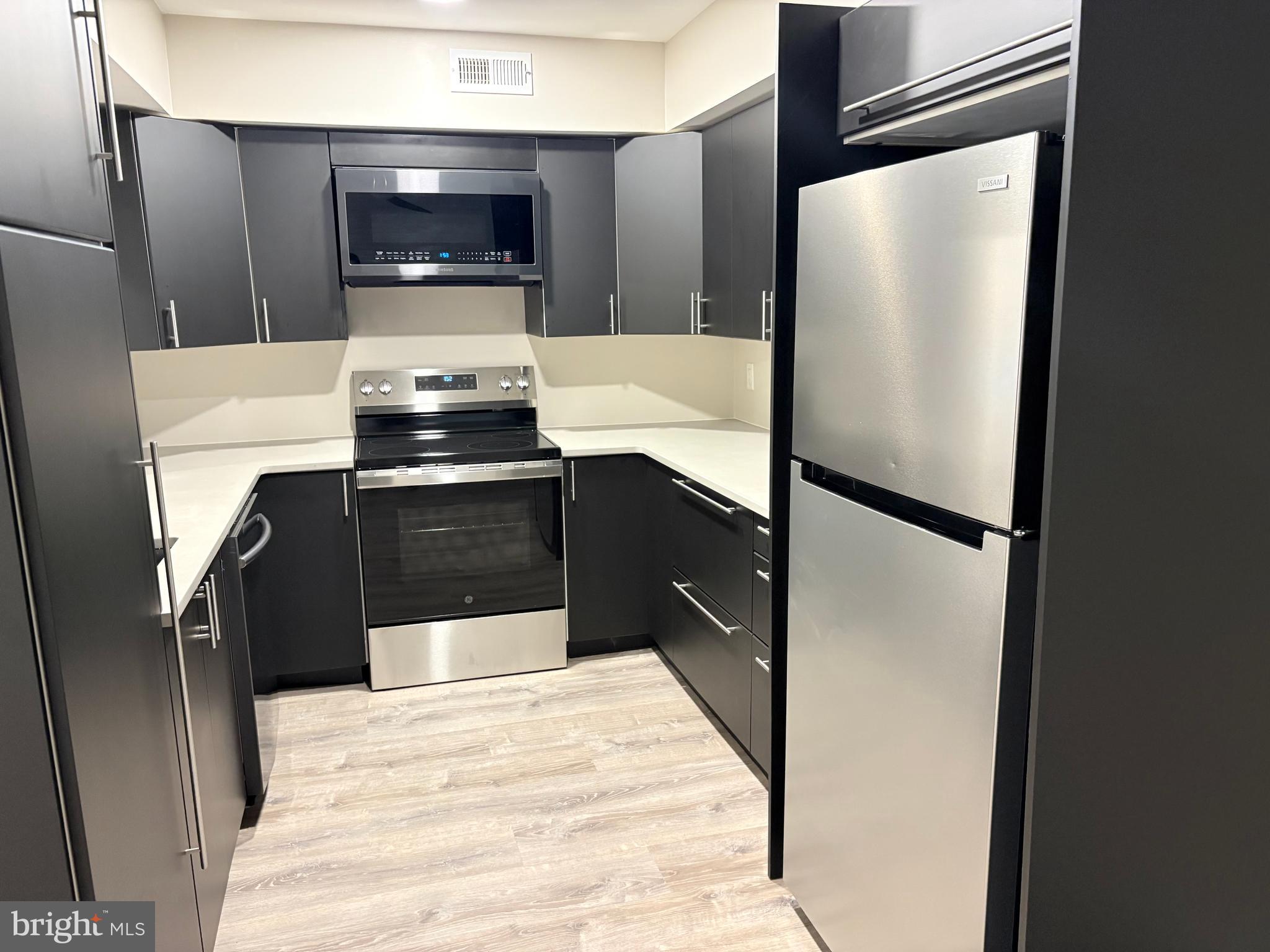 601 Gregorys Way Voorhees, NJ 08043 - Photo 2 of 8 a kitchen with a refrigerator and a sink