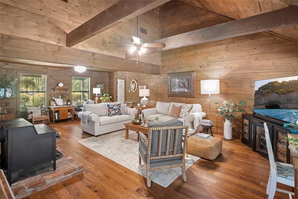 1516 Rancho Road Quinlan, TX 75474 - Photo 7 of 40 a living room with furniture a dining table and wooden floor