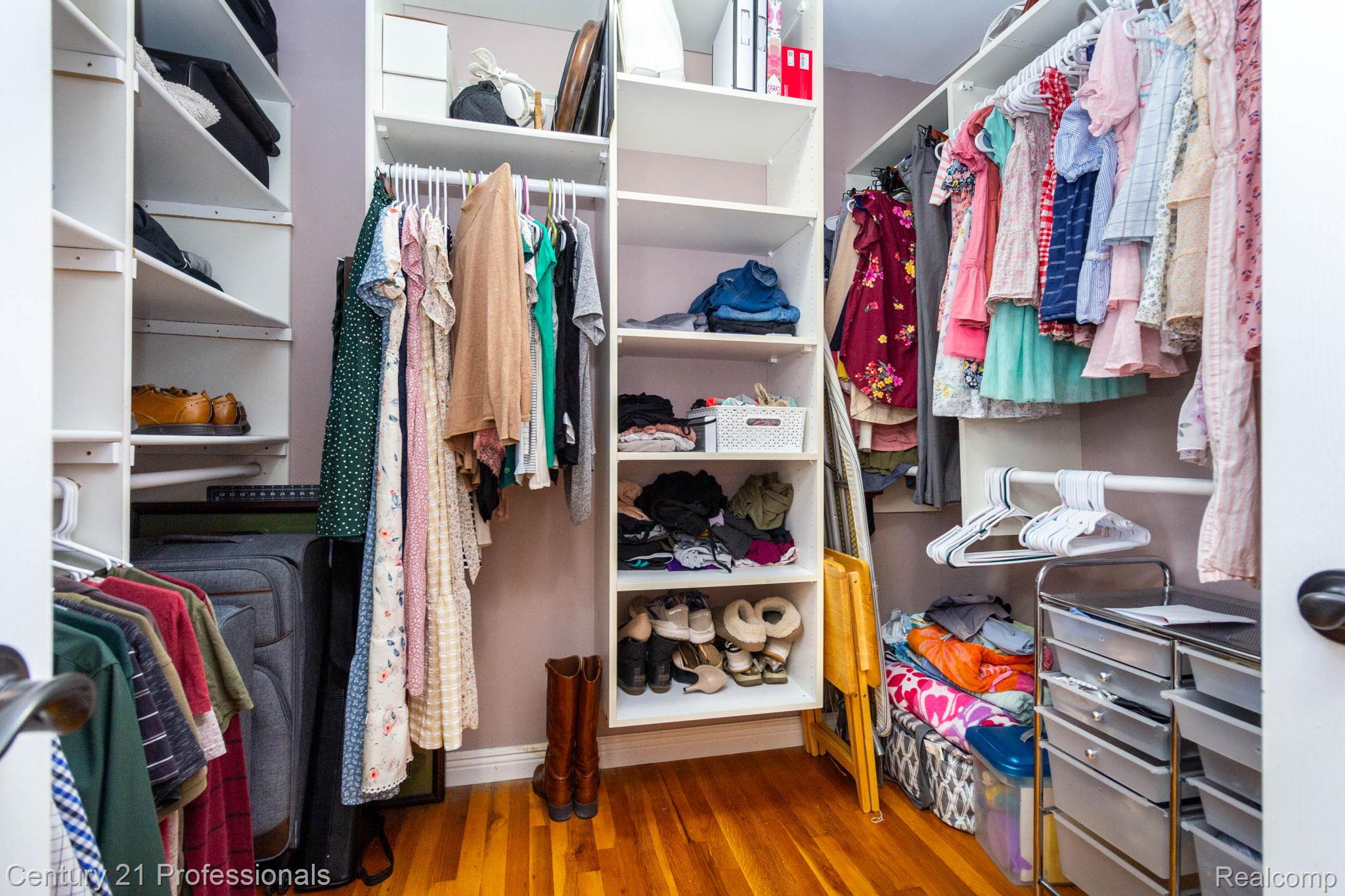 671 Bridgestone Drive Rochester, MI 48309 - Photo 24 of 50 Custom closet system featuring multiple hanging rods, adjustable shelving, and wood-finish flooring