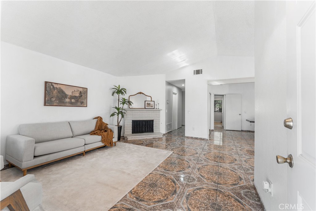 3542 East Ave R 10 Palmdale, CA 93550 - Photo 6 of 35 a living room with furniture and a fireplace