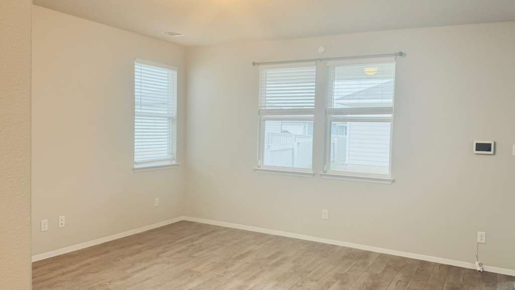 1305 Goforth Road Kyle, TX 78640 - Photo 12 of 23 Spare room featuring light wood-type flooring and baseboards