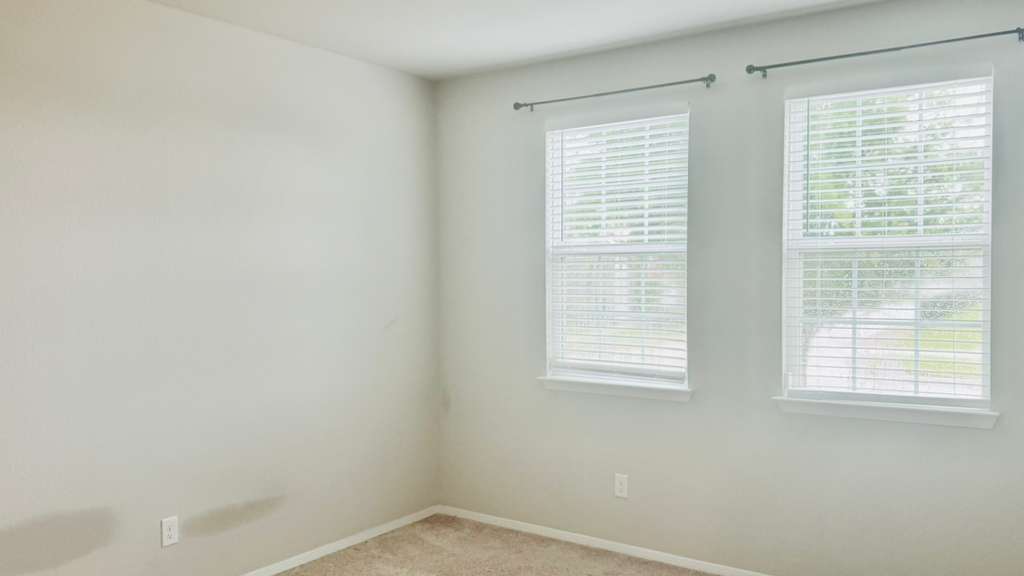 1305 Goforth Road Kyle, TX 78640 - Photo 13 of 23 Spare room featuring light colored carpet and baseboards