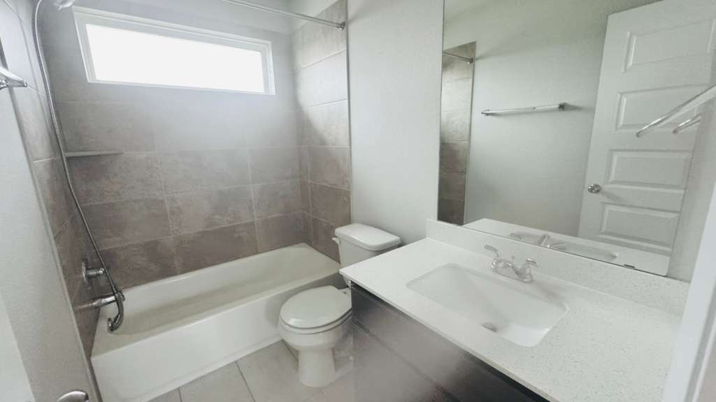 1305 Goforth Road Kyle, TX 78640 - Photo 17 of 23 Full bath featuring vanity, tub / shower combination, and light tile patterned floors