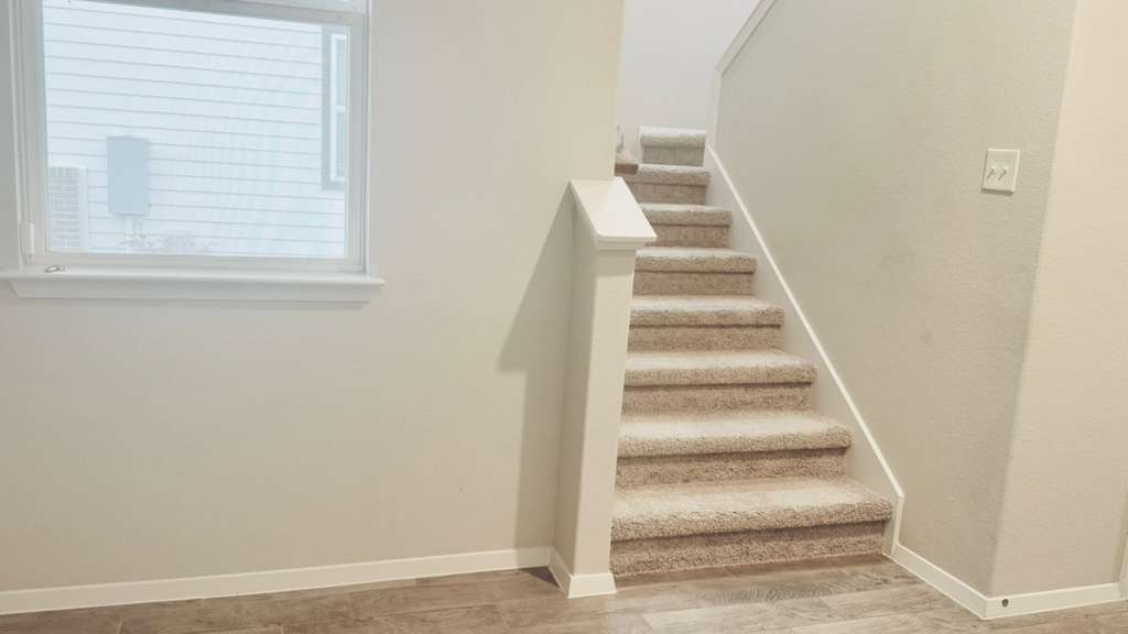 1305 Goforth Road Kyle, TX 78640 - Photo 7 of 23 Stairway with baseboards and wood finished floors