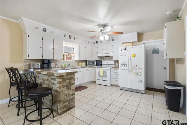 a living room with couch and a potted plant
