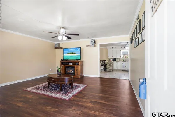 a bedroom with bed and wooden floor