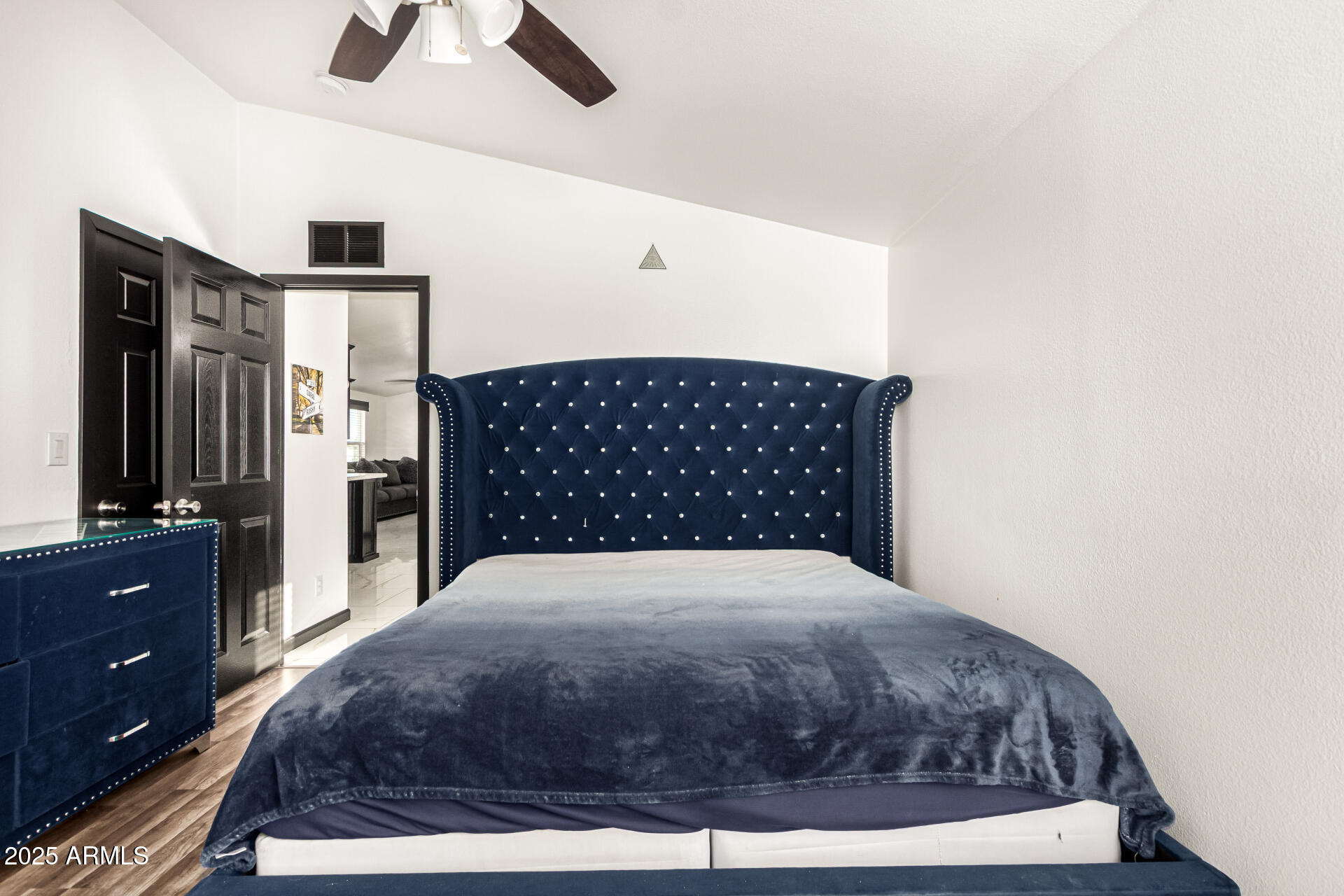 9431 East Coralbell Avenue, Unit 80 Mesa, AZ 85208 - Photo 11 of 22 a large bed in a bedroom and a chandelier