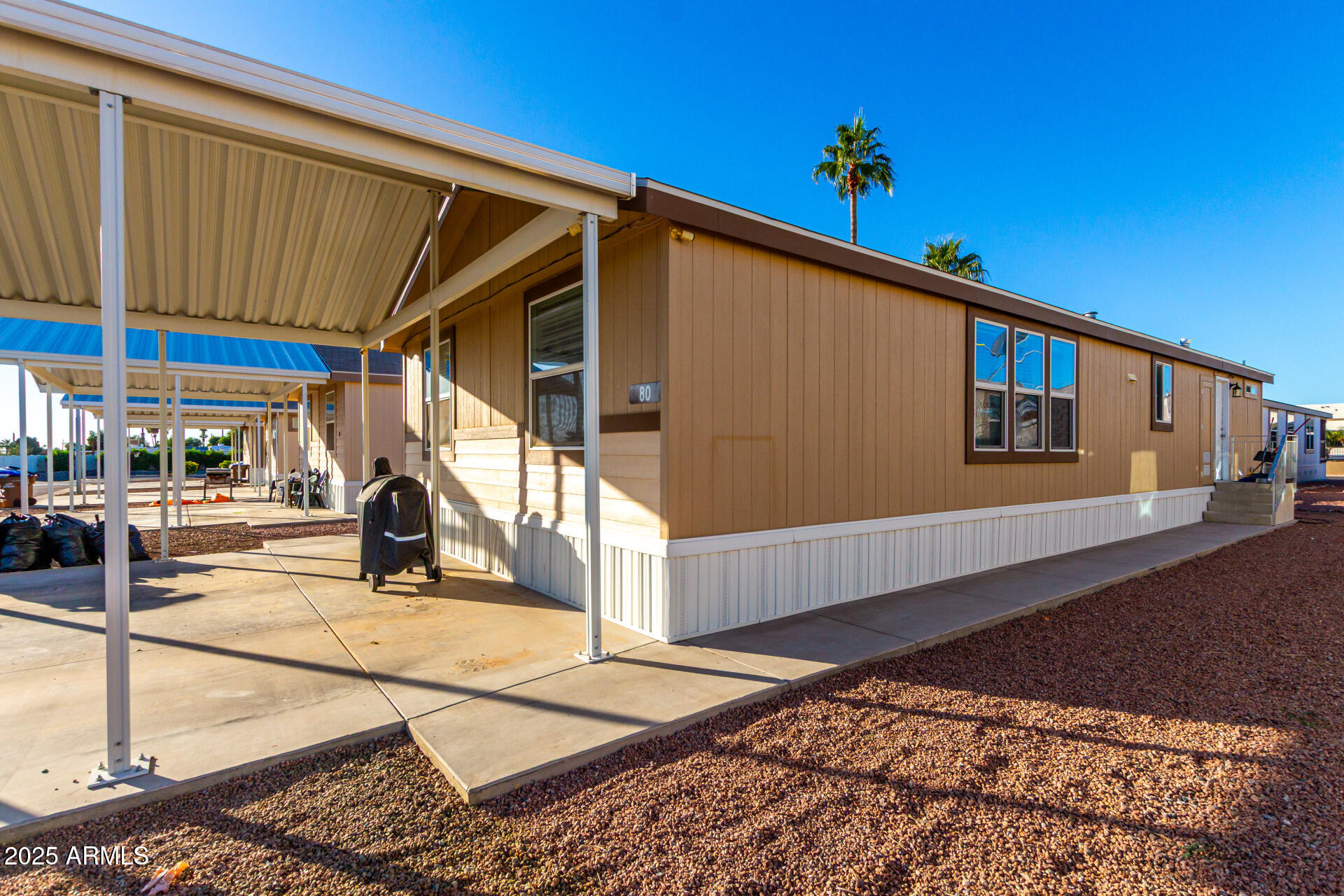 9431 East Coralbell Avenue, Unit 80 Mesa, AZ 85208 - Photo 21 of 22 a view of a patio with a table and chairs
