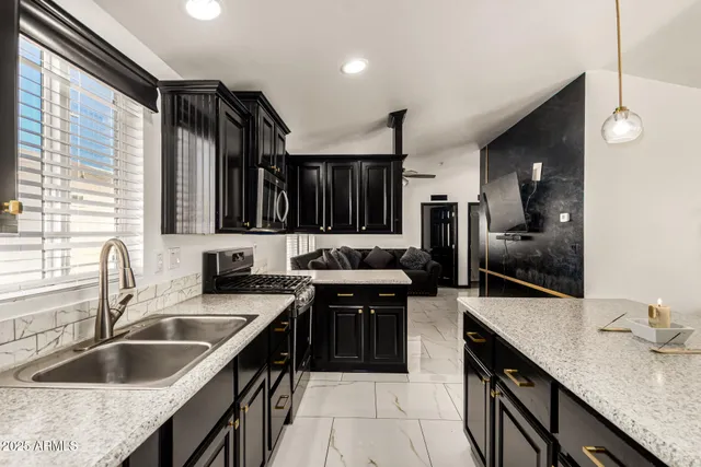 a kitchen with a sink stove top oven and cabinets