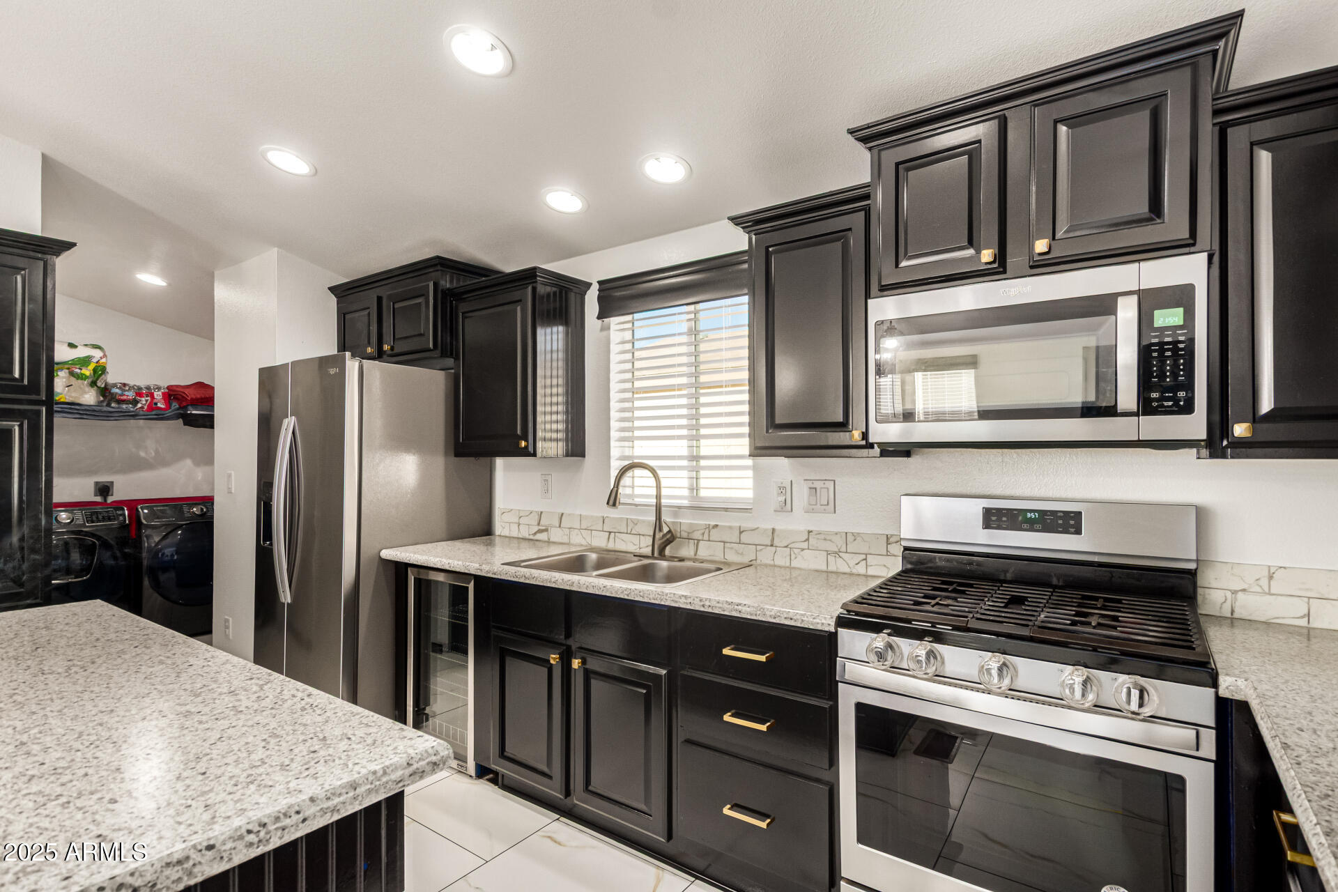 9431 East Coralbell Avenue, Unit 80 Mesa, AZ 85208 - Photo 6 of 22 a kitchen with stainless steel appliances granite countertop a stove refrigerator and microwave