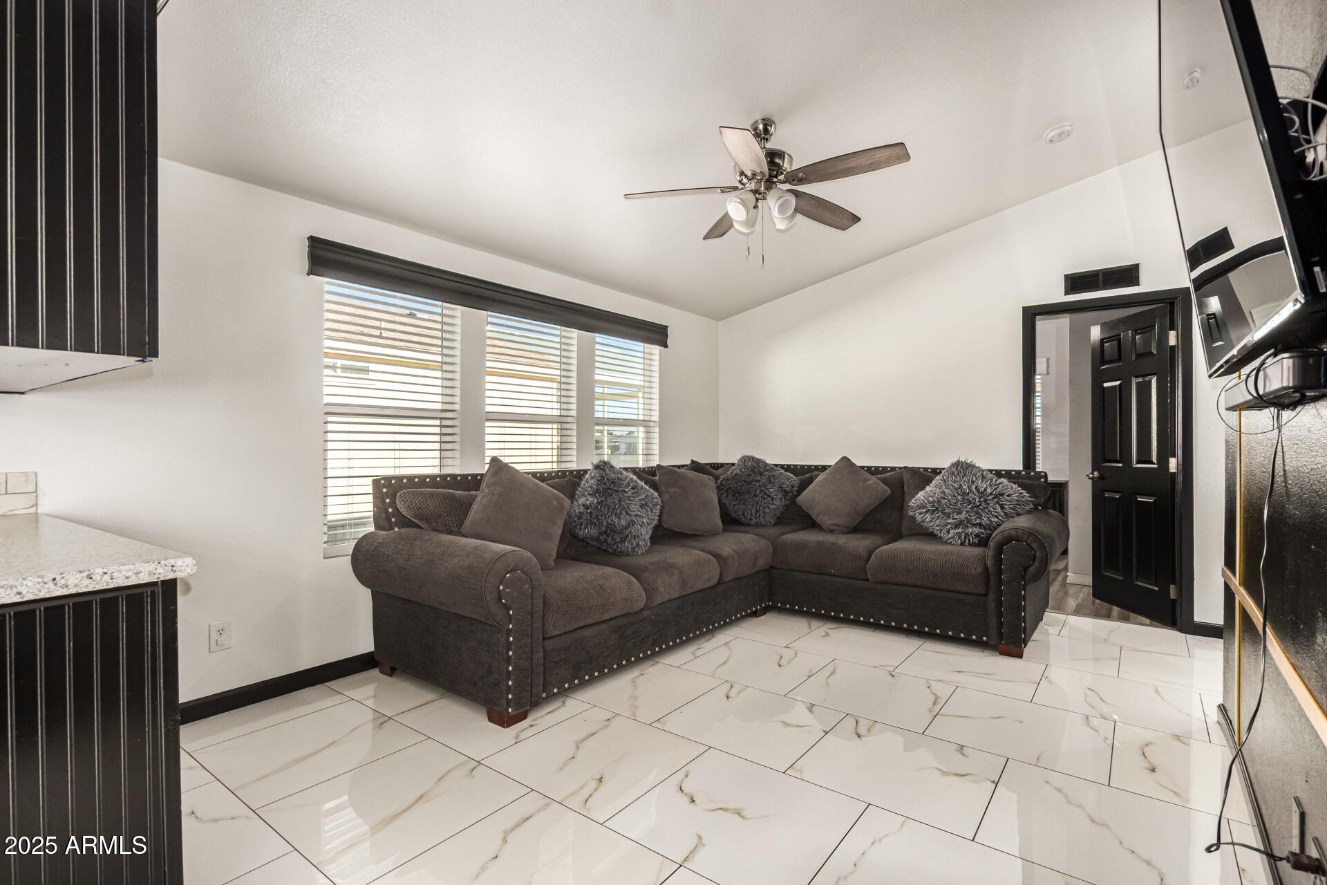 9431 East Coralbell Avenue, Unit 80 Mesa, AZ 85208 - Photo 8 of 22 a living room with a couch and a window