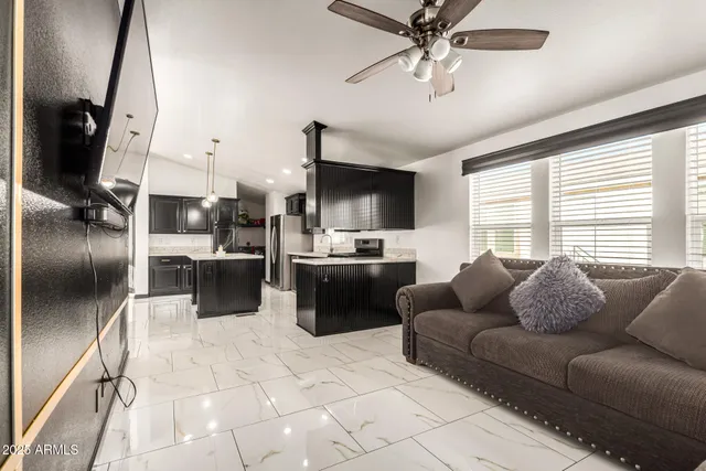 a living room with furniture a flat screen tv and a window