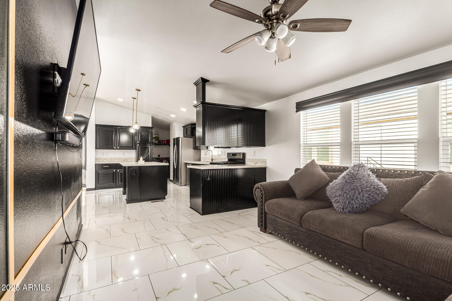 9431 East Coralbell Avenue, Unit 80 Mesa, AZ 85208 - Photo 10 of 22 a living room with furniture a flat screen tv and a window