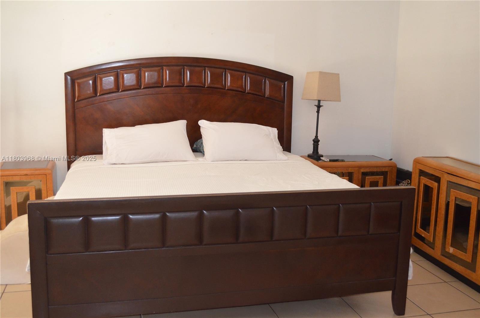 13499 Biscayne Boulevard, Unit 702 North Miami, FL 33181 - Photo 13 of 31 a bedroom with a bed and a dresser