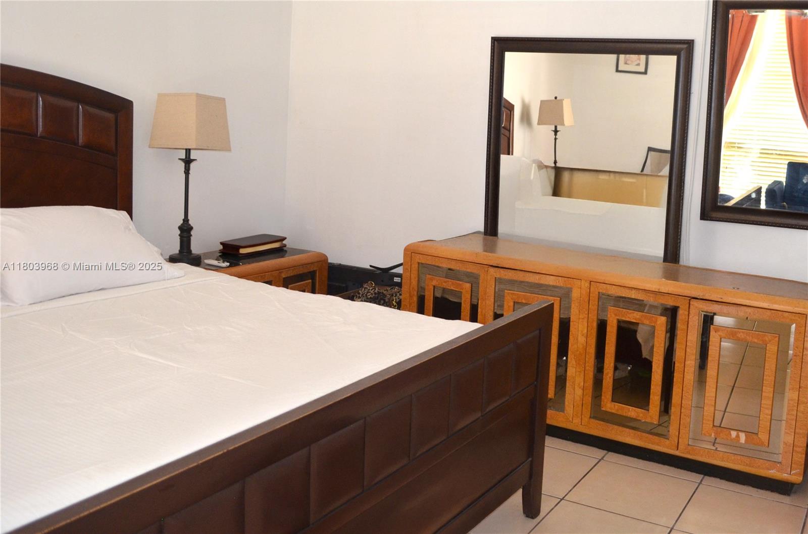 13499 Biscayne Boulevard, Unit 702 North Miami, FL 33181 - Photo 14 of 31 a bedroom with two cabinet and a window