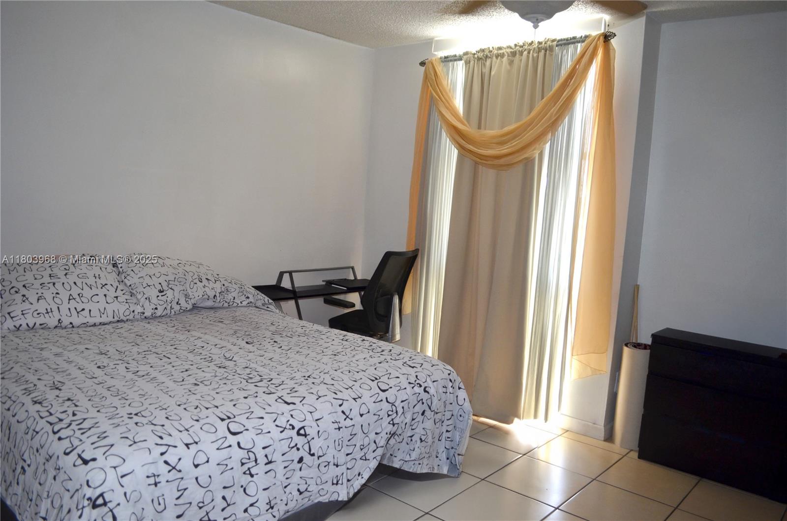 13499 Biscayne Boulevard, Unit 702 North Miami, FL 33181 - Photo 17 of 31 a bedroom with a bed and a window