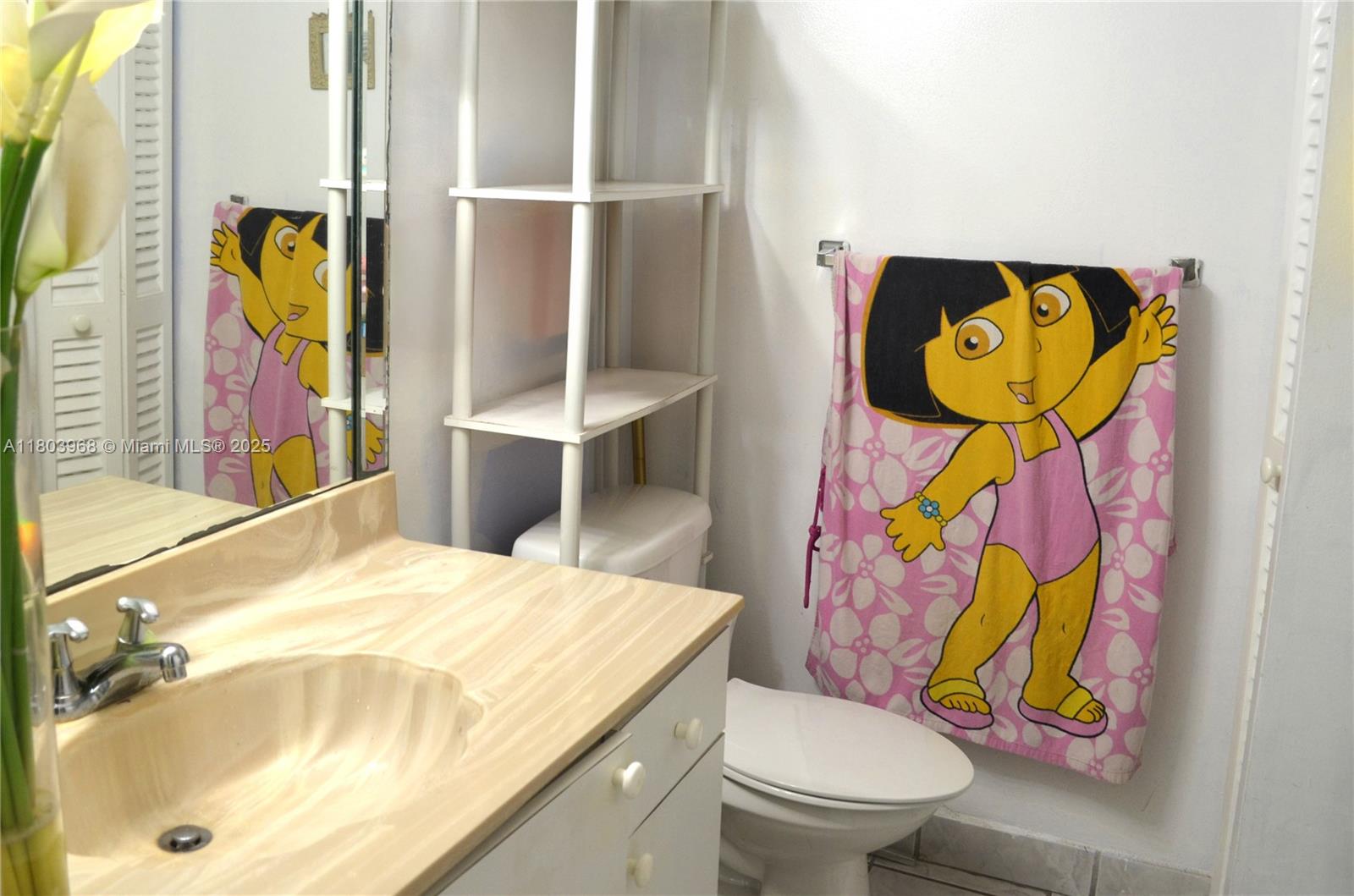 13499 Biscayne Boulevard, Unit 702 North Miami, FL 33181 - Photo 18 of 31 a bathroom with a sink mirror vanity and toilet