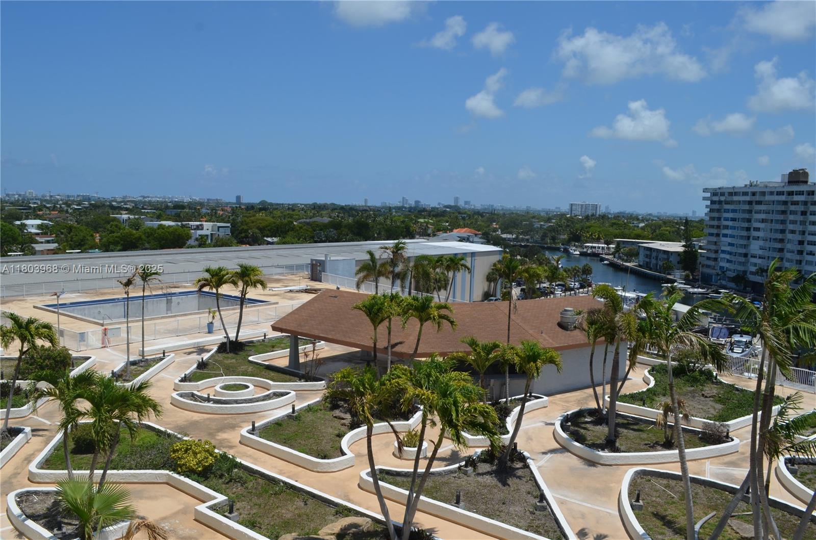 13499 Biscayne Boulevard, Unit 702 North Miami, FL 33181 - Photo 21 of 31 a view of a chairs and table in patio
