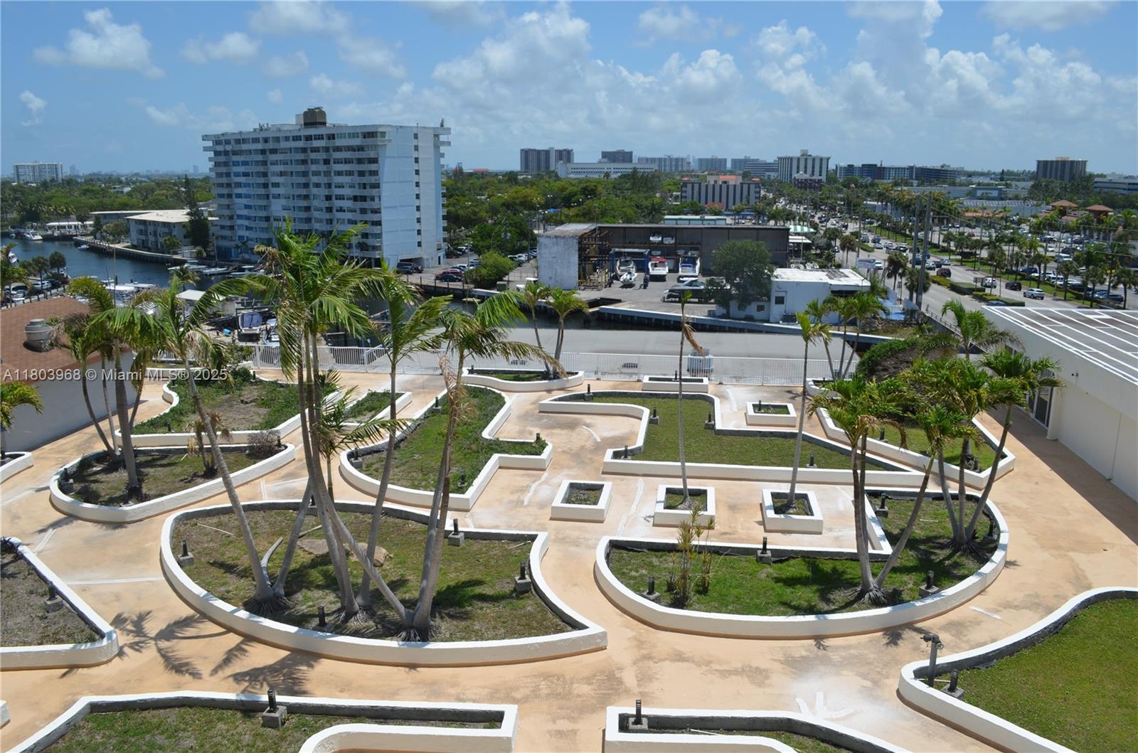 13499 Biscayne Boulevard, Unit 702 North Miami, FL 33181 - Photo 23 of 31 a small white building sitting next to a lake