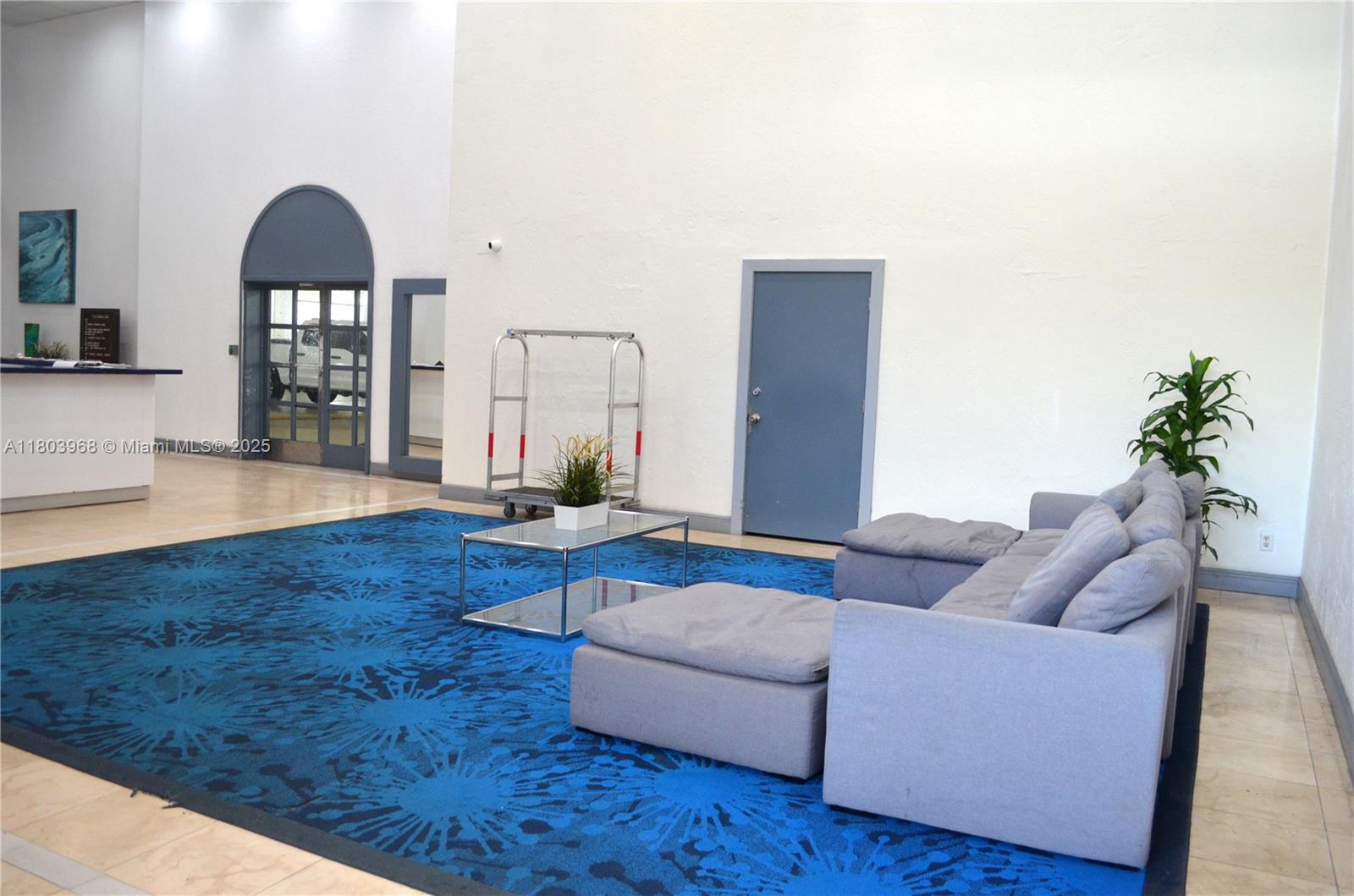 13499 Biscayne Boulevard, Unit 702 North Miami, FL 33181 - Photo 5 of 31 a living room with furniture and wooden floor