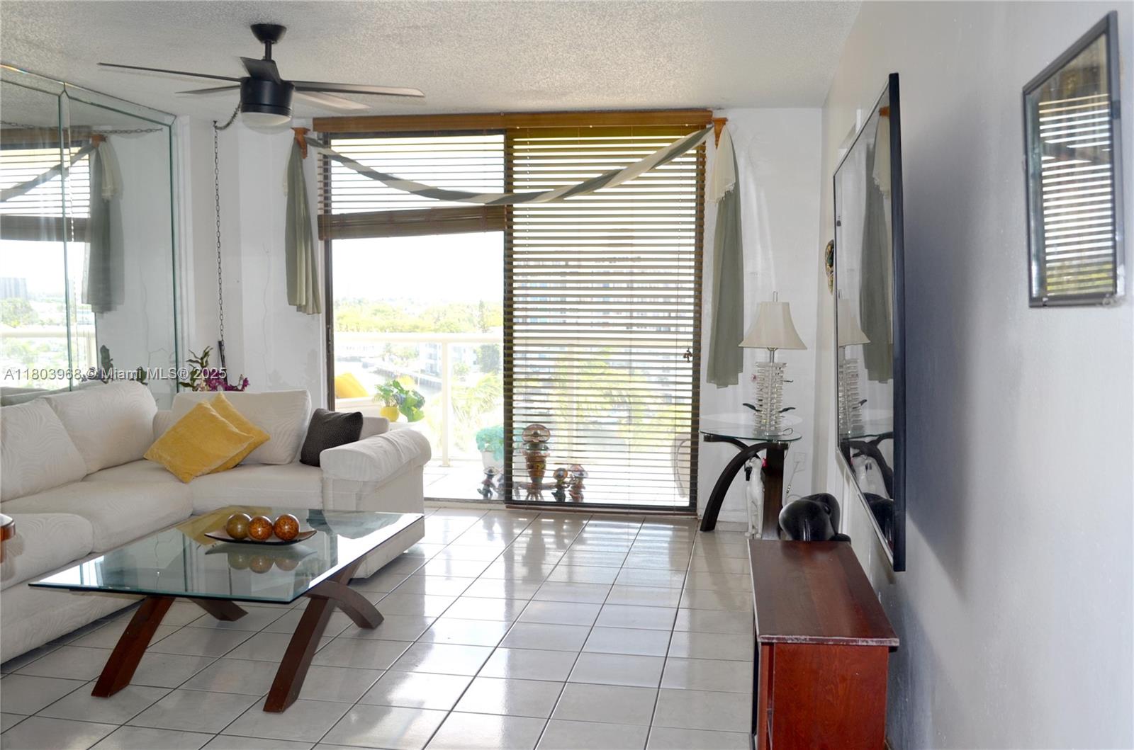 13499 Biscayne Boulevard, Unit 702 North Miami, FL 33181 - Photo 9 of 31 a living room with furniture and a large window