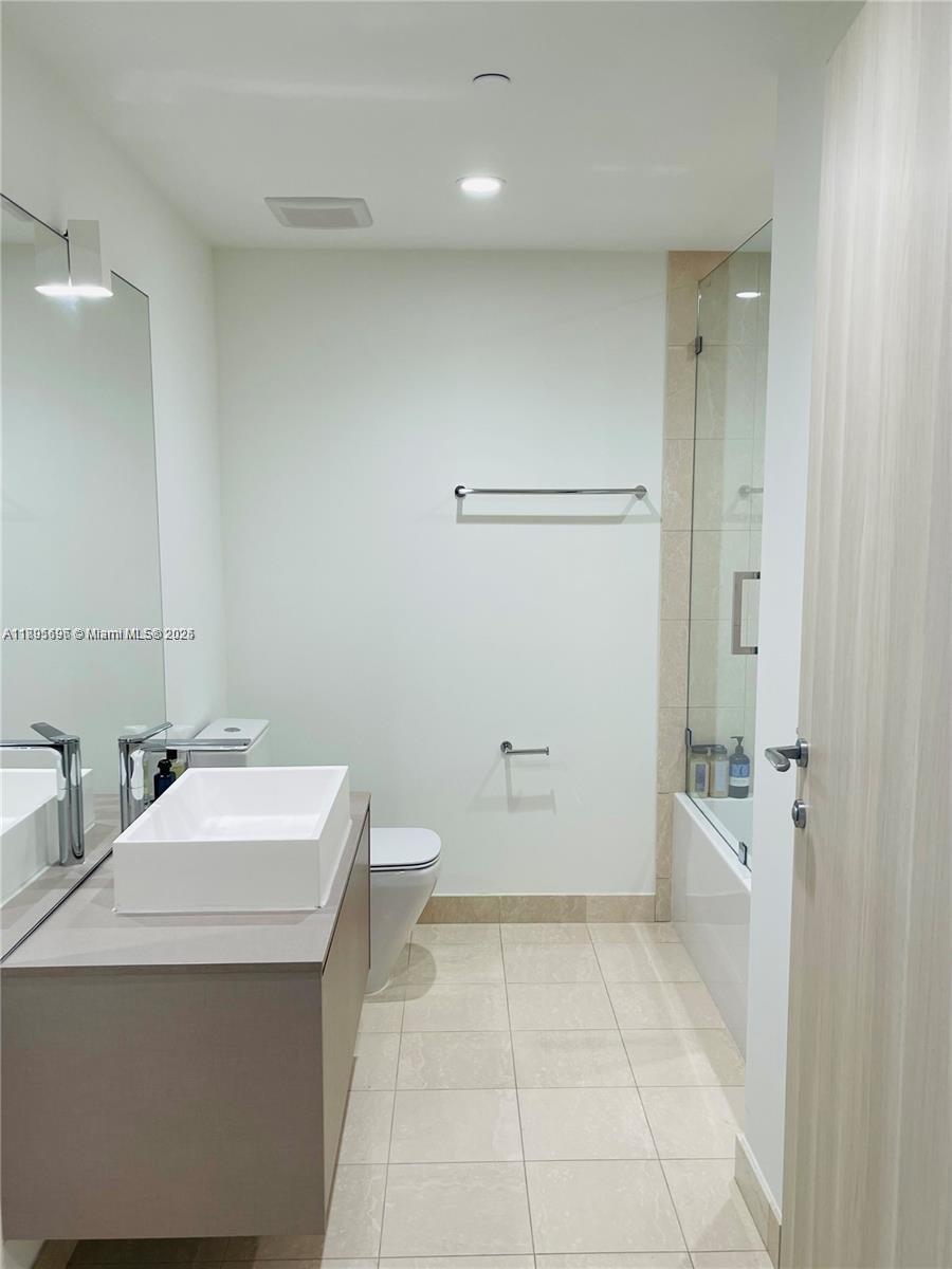 1000 Brickell Plaza, Unit 3905 Miami, FL 33131 - Photo 15 of 18 a bathroom with a sink a toilet and shower