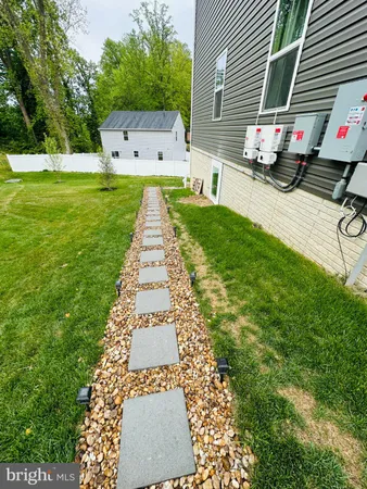 a backyard of a house with table and chairs
