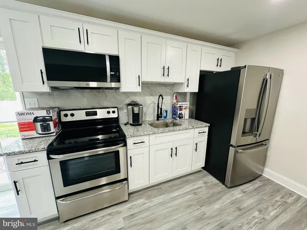 a kitchen with a stove microwave and refrigerator