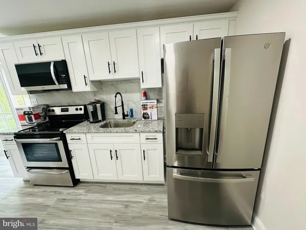 a kitchen with stainless steel appliances and wooden cabinets