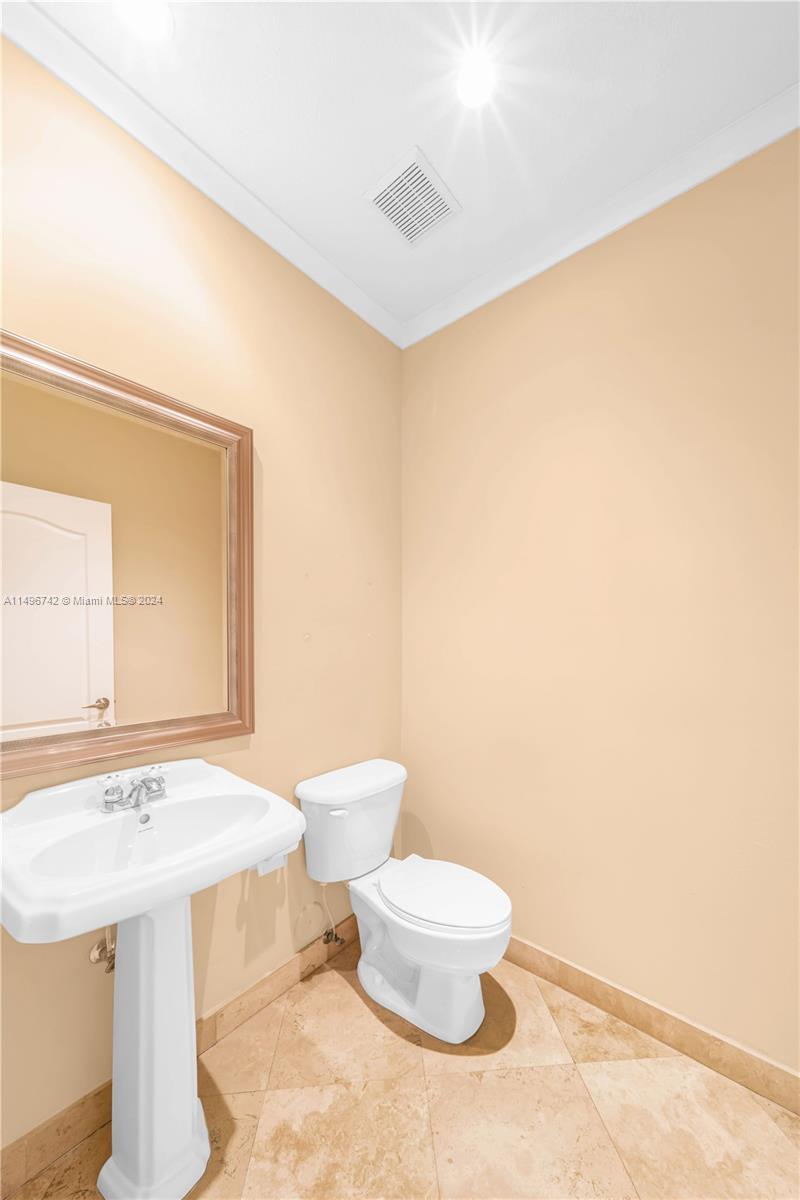 2829 Coconut Avenue, Unit 2829 Miami, FL 33133 - Photo 12 of 28 a bathroom with a sink a toilet and mirror