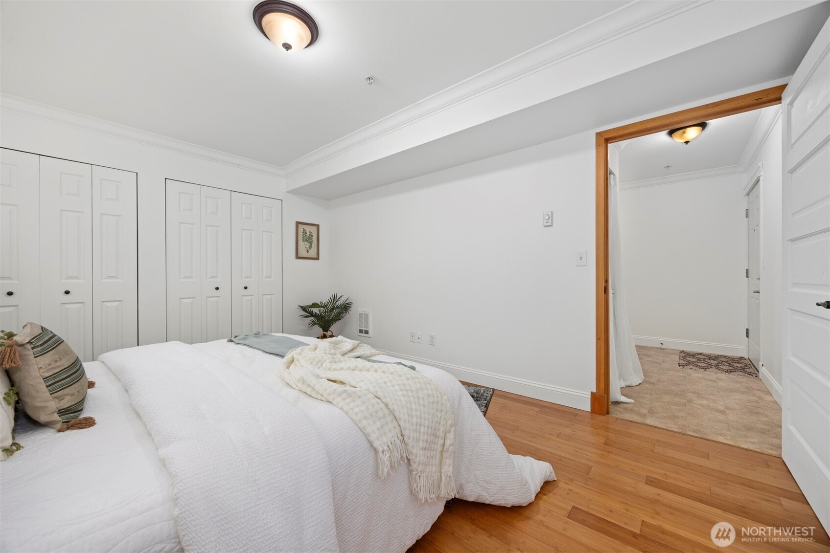 1001 North State Street, Unit 403 Bellingham, WA 98225 - Photo 11 of 34 a bedroom with a bed and a mirror