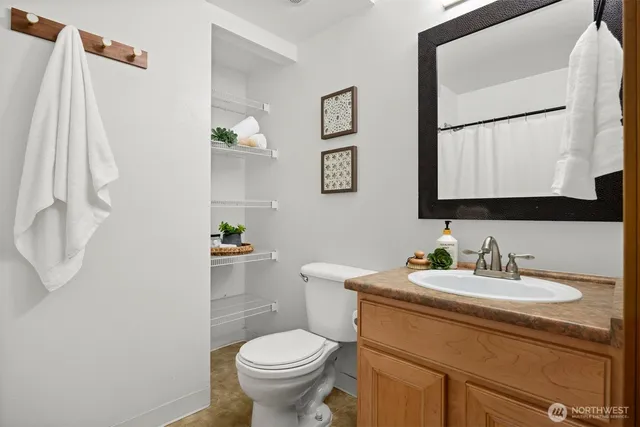 a bathroom with a sink toilet and mirror