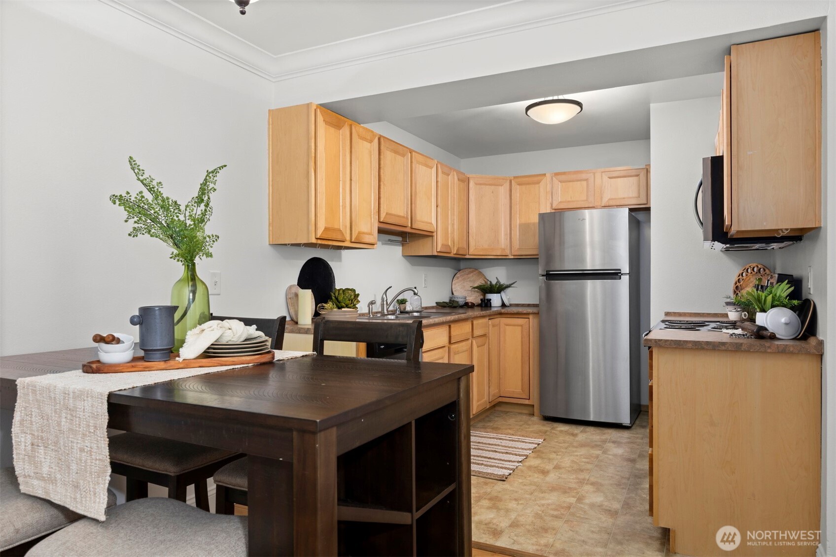 1001 North State Street, Unit 403 Bellingham, WA 98225 - Photo 15 of 34 a kitchen with refrigerator and cabinets