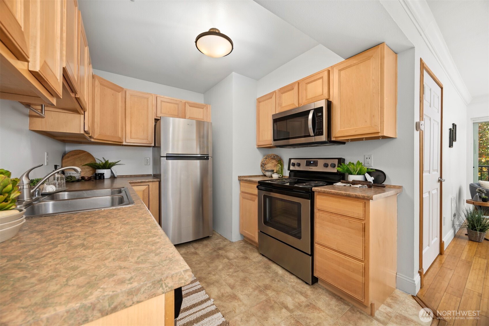 1001 North State Street, Unit 403 Bellingham, WA 98225 - Photo 17 of 34 a kitchen with granite countertop a refrigerator stove top oven a sink and dishwasher
