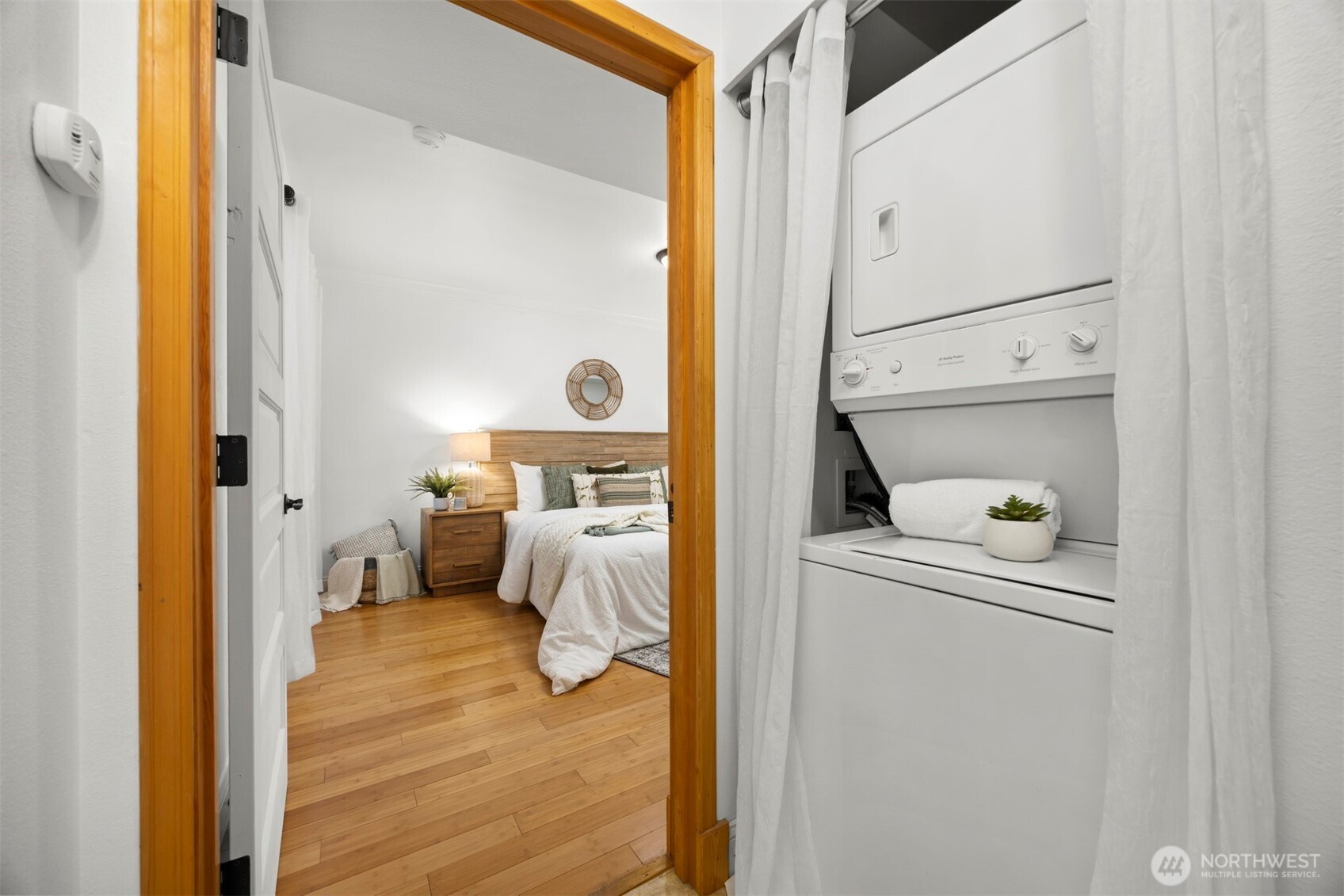 1001 North State Street, Unit 403 Bellingham, WA 98225 - Photo 6 of 34 a bedroom with a bed and a mirror