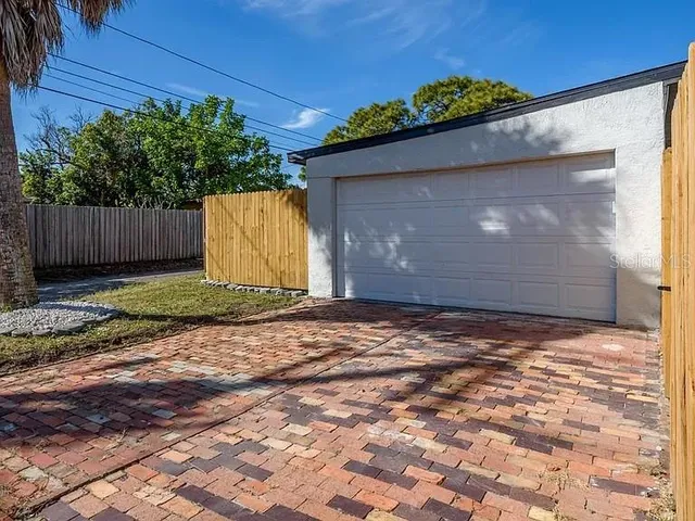 a view of a backyard with plants and a patio