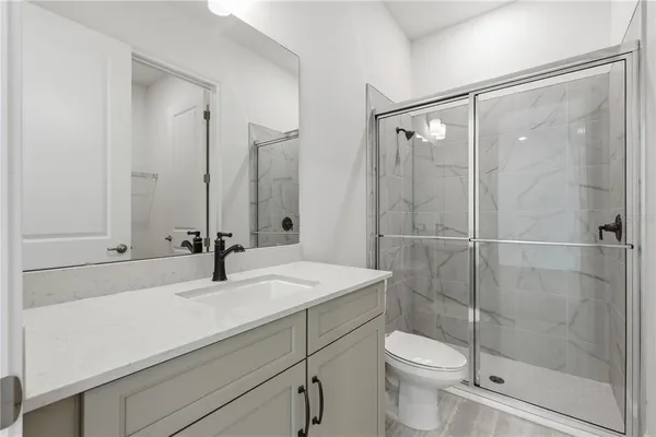 a bathroom with a sink toilet and shower