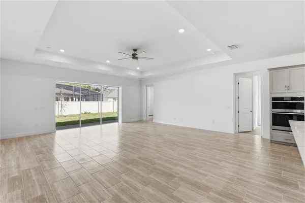 a view of empty room with wooden floor and fireplace