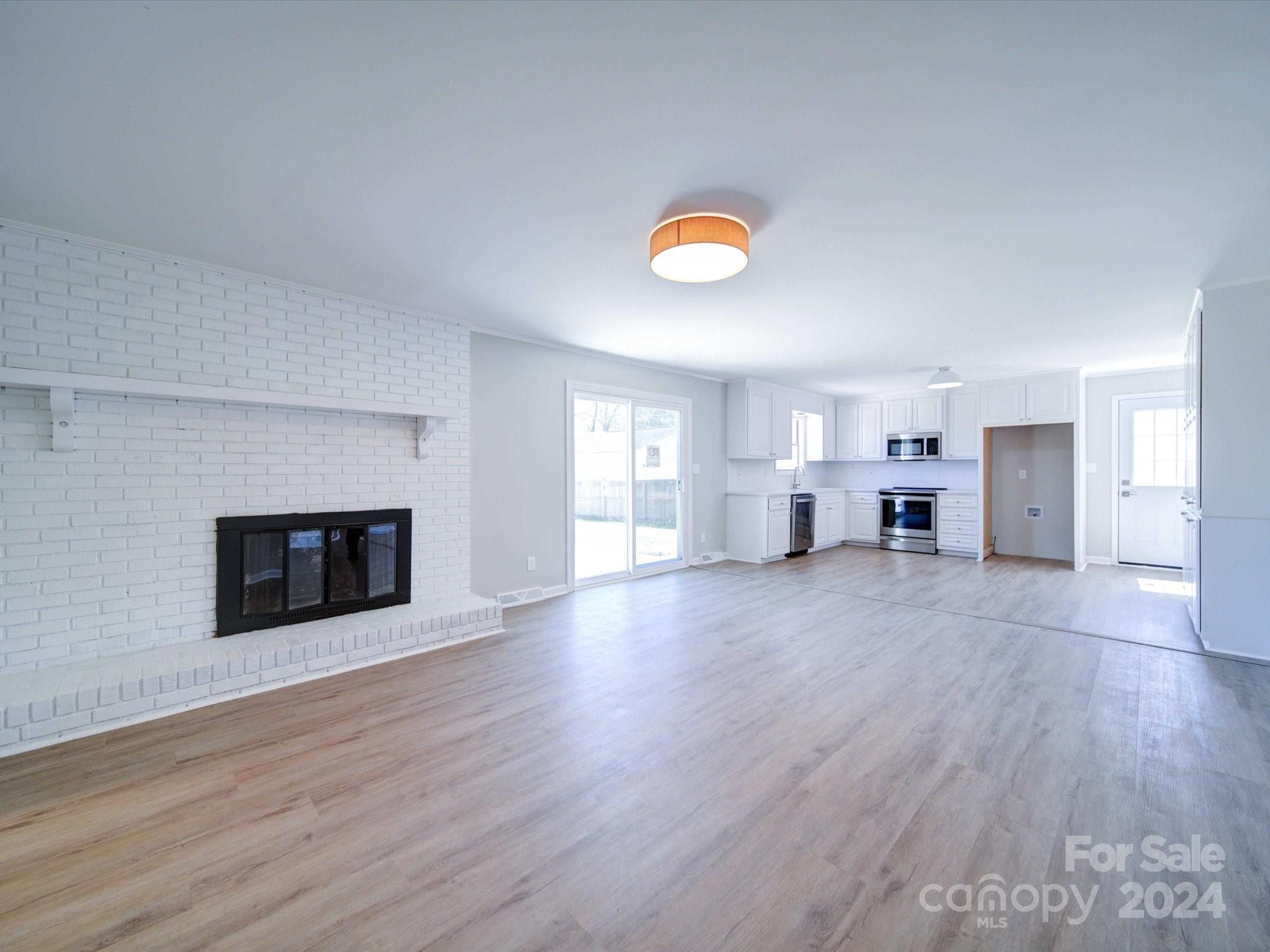 101 Hedgestone Drive Gastonia, NC 28056 - Photo 17 of 39 a view of empty room with wooden floor and fireplace