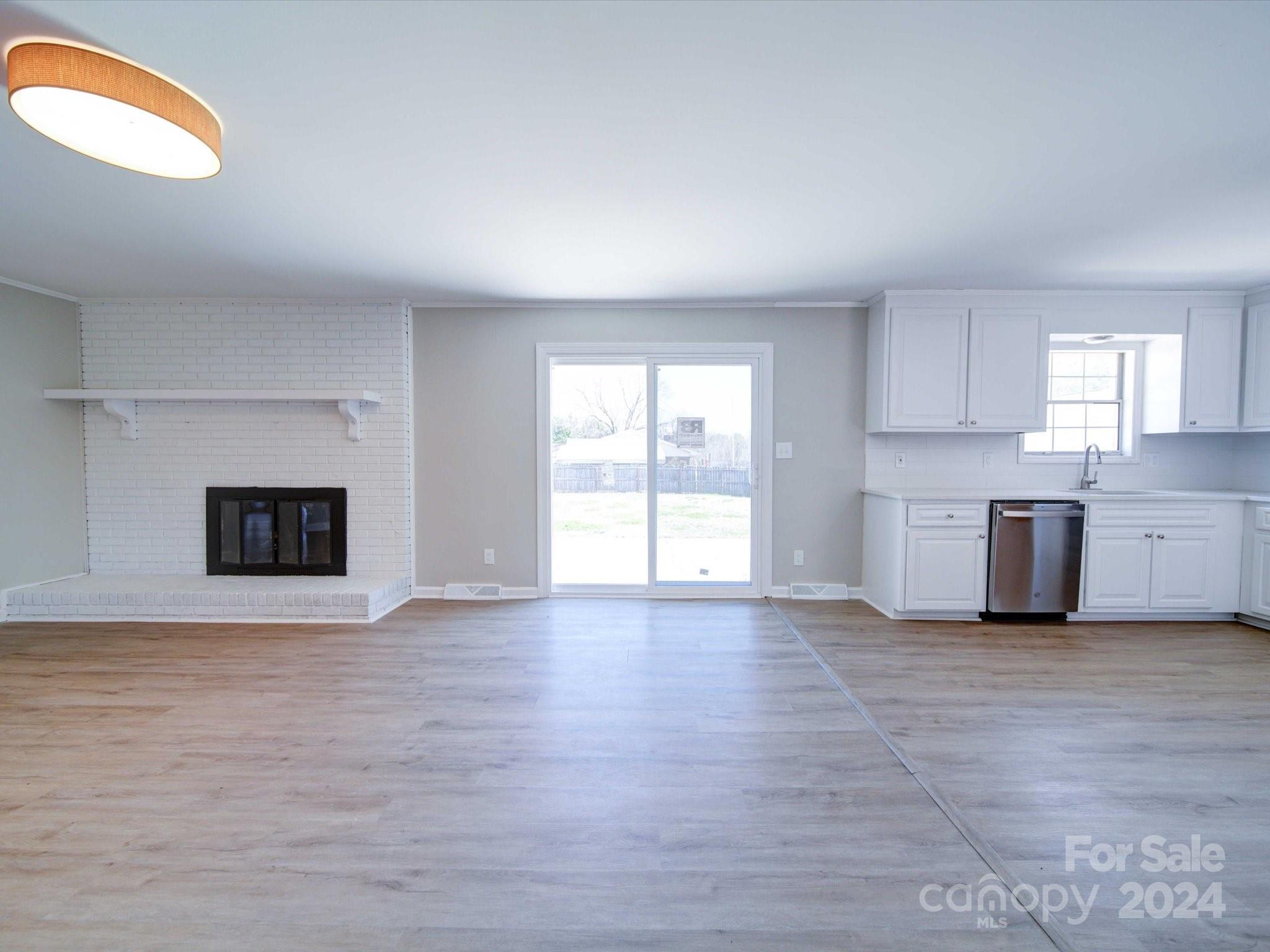 101 Hedgestone Drive Gastonia, NC 28056 - Photo 18 of 39 a view of a kitchen with a sink dishwasher and a fireplace