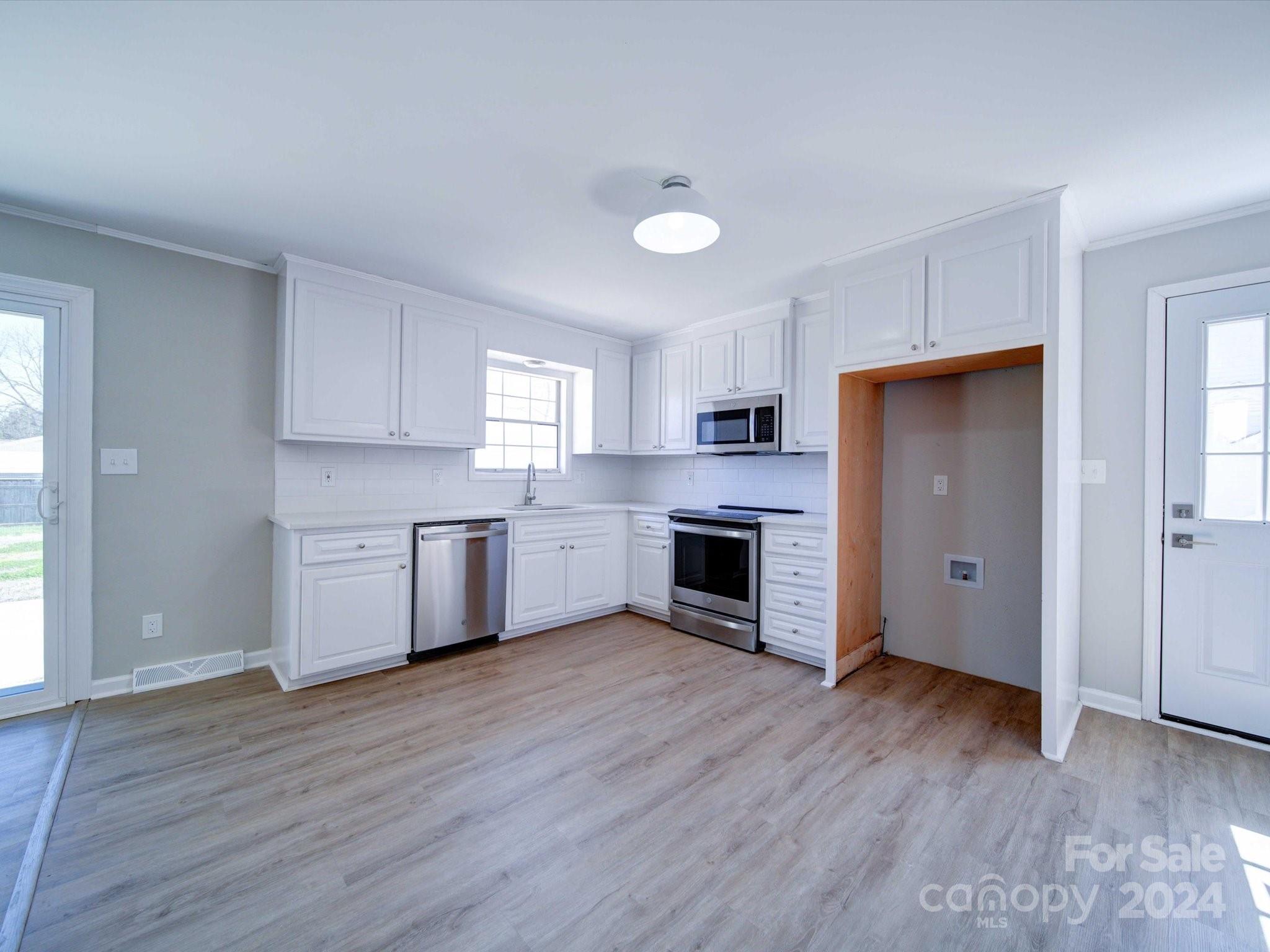 101 Hedgestone Drive Gastonia, NC 28056 - Photo 21 of 39 a view of kitchen with granite countertop wooden floors stainless steel appliances and sink